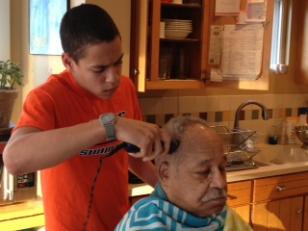 Zach giving Grandpa Moragne a haircut